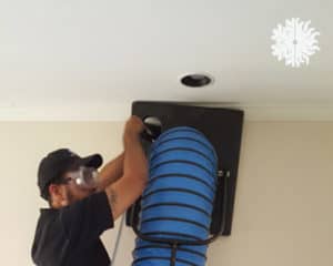 Technician cleaning ducts and vents