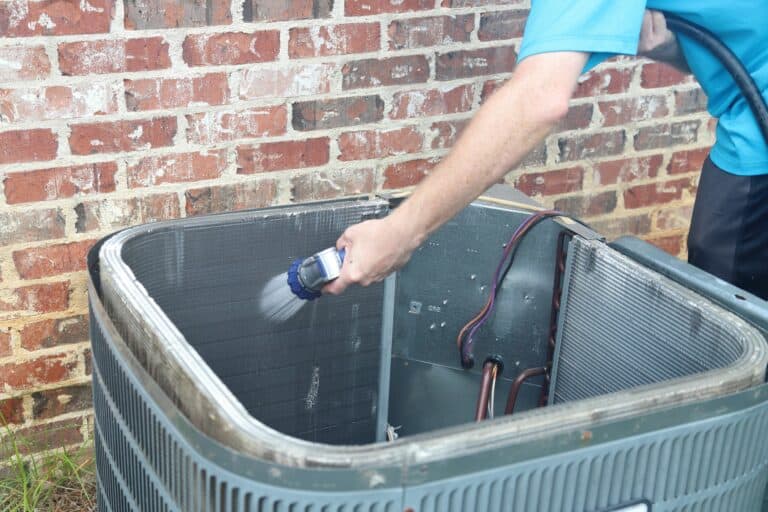 washing AC coil with hose and water